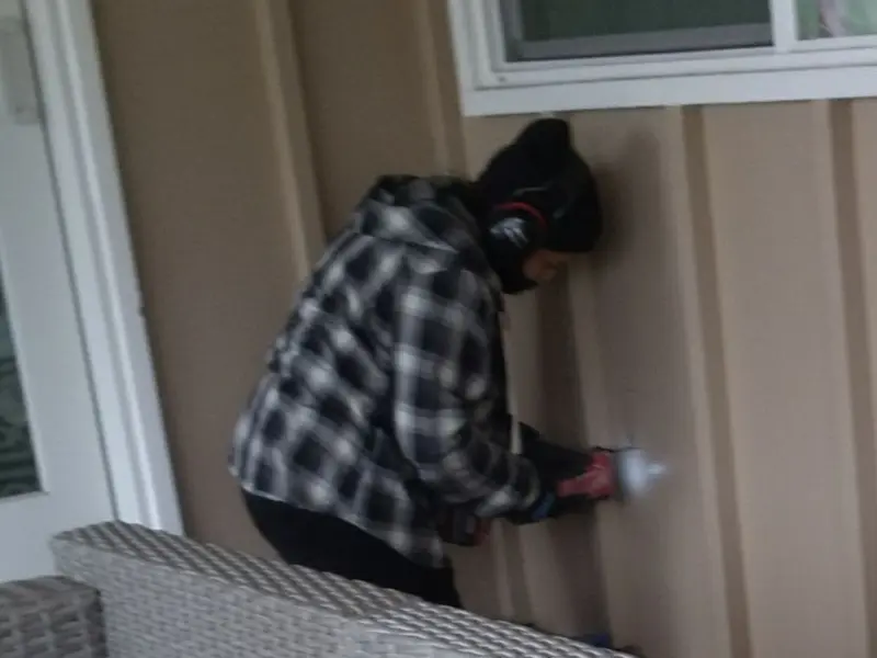 Professional electrician installing an exterior outlet in University